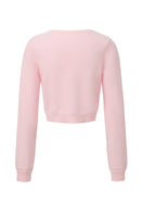 Pink knitted Mirabelle cardigan by Nana Jacqueline, shown from the back, with ribbed cuffs and cozy textured knit.