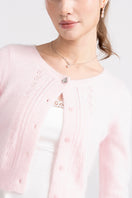 Pink knitted Mirabelle cardigan by Nana Jacqueline, featuring a cozy, stylish design with a textured knit pattern.