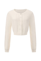 White knitted Mirabelle cardigan by Nana Jacqueline, featuring a cozy, stylish design with a button-up front and ribbed details.