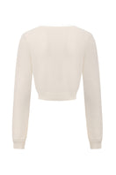 White knitted Mirabelle cardigan by Nana Jacqueline, back view showing textured fabric and relaxed fit.