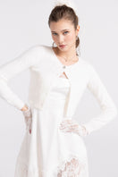 White knitted cardigan from Nana Jacqueline's Mirabelle collection, featuring a cozy, stylish design perfect for layering.