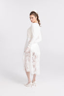 White knitted Mirabelle cardigan by Nana Jacqueline, featuring a cozy, stylish design with a front button closure.