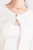 White knitted Mirabelle cardigan by Nana Jacqueline, featuring a cozy, stylish design with a textured knit pattern.