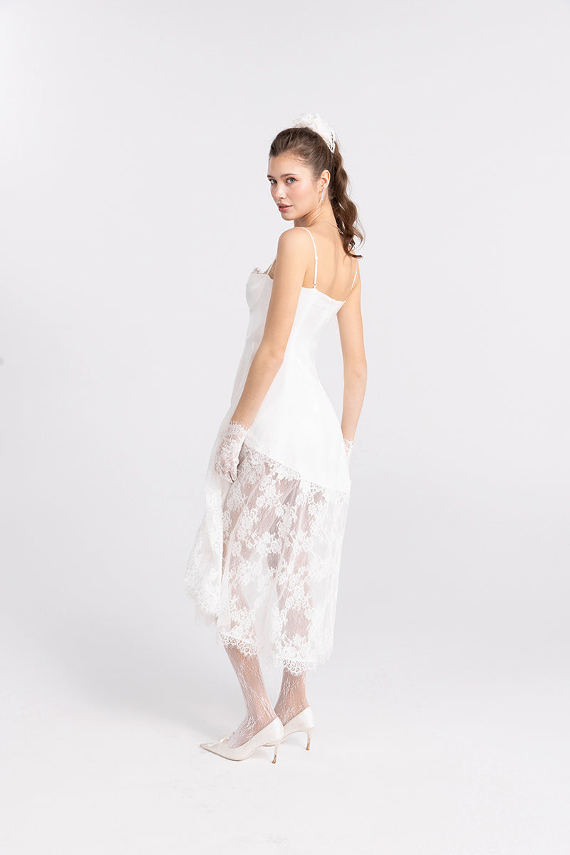White Nana Jacqueline Mirabelle satin maxi dress displayed on a model, showcasing elegant midi dress design and flowing fabric.