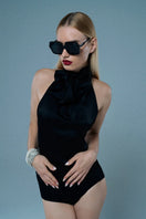 Mirel Prentice satin tie-neck open-back top displayed on a hanger, featuring a sleek, shiny fabric and elegant design.