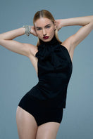Mirel Prentice satin tie-neck open back top featuring a sleek, elegant design with a high neckline and flowing fabric.