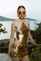 Hand-crochet mini skirt with sequins in matte gold by Mirel Prentice, featuring intricate crochet details and shimmering embellishments.
