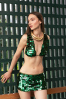 Emerald green hand-crochet mini skirt with sequin embellishments by Mirel Prentice, showcasing intricate detail and vibrant color.