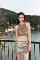 Bronze hand-crochet mini skirt with pearl embellishments by Mirel Prentice, showcasing intricate detailing and stylish design.