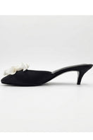 Black YASSMIN SALEH Mist Heels featuring a stylish design, shown outdoors with a ghostly background.