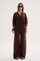 Nelblu Aurora top sweater in warm brown worn by a model, showcasing a cozy, stylish knit design.
