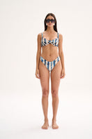 Nelblu Amanecer bikini bottom with full coverage in vibrant blue print, shown on a model.
