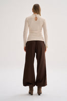 Nelblu KAIA beige top worn by a model, soft fabric, casual style, perfect for everyday wear.