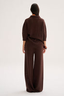 Nelblu Aurora top sweater in brown worn by a model, showcasing a cozy, stylish knit design.
