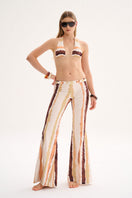 Nelblu Jagger Pant in Print Naranja cover-up featuring vibrant orange and white pattern, modeled on a woman.