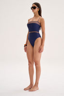 Nelblu Caliz one-piece swimsuit in blue blueberry, featuring a sleek design and comfortable fit, worn by a model.