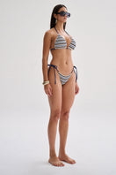 Nelblu LILI top bikini in vibrant blue print, model wearing stylish swimwear with adjustable straps and tropical design.