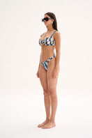 Nelblu Amanecer top bikini in blue printed fabric worn by a model, showcasing stylish swimwear design.
