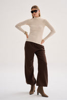 Nelblu beige Kaia top worn by a model, featuring a stylish, fitted design ideal for casual or chic outfits.