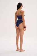 Nelblu Caliz one-piece swimsuit in blueberry color, featuring a stylish fit on a model, ideal for beach or pool wear.