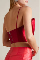 Model wearing a red SemSem cropped plissé-satin bustier top, showing the back detail and fitted style.