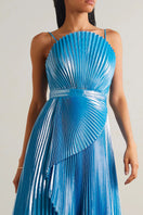 Model wearing SemSem blue Capri draped plissé lamé maxi gown, front view showcasing elegant pleated fabric and flowing silhouette.