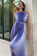 Model wearing a purple draped silk-blend plissé lamé maxi gown by SemSem, front view showcasing flowing fabric and elegant silhouette.
