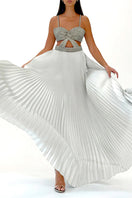 Model wearing SemSem white and silver pleated silk maxi skirt, front view showcasing flowing metallic fabric and elegant design.