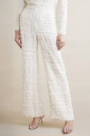White silk chiffon embellished wide-leg pants by SemSem worn by a model, showcasing flowing fabric and elegant design.