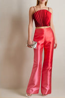 Red SemSem cropped plissé satin bustier top worn by a model, showcasing the elegant pleated design and fitted style.