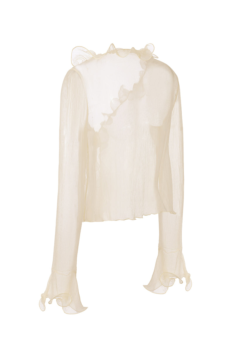 Nana Jacqueline Monroe top in ivory with ruffle details, shown from the back on a champagne-colored blouse.
