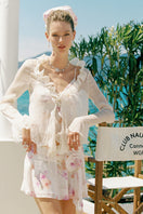 Nana Jacqueline Monroe ivory ruffle blouse with puffed sleeves, styled in a fashion campaign photo.