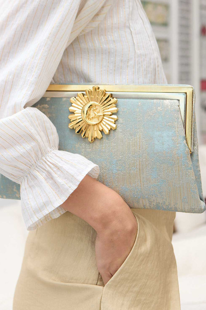 Multicolor Moon Rays on Lagoon Grace clutch bag by Sarah's Bag featuring vibrant, artistic design with a sleek shape.