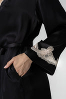 NK IMODE Cult Mia X Morgan short black robe with champagne-colored trim, featuring soft fabric and elegant design details.