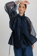 Navy blue Mousa blouse by ANA + MARIA, featuring a stylish, relaxed fit and classic design, shown on a model.