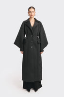 Black MS. Doll coat by Stolen Stores displayed on a mannequin, featuring a stylish design and tailored fit.