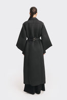 Black coat from the MS. DOLL collection by Stolen Stores, displayed on a mannequin with stylish details.