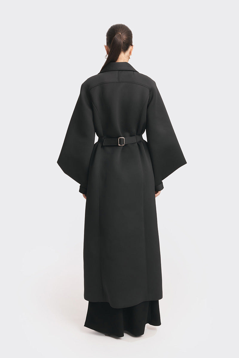 Black coat from the MS. DOLL collection by Stolen Stores, displayed on a mannequin with stylish details.