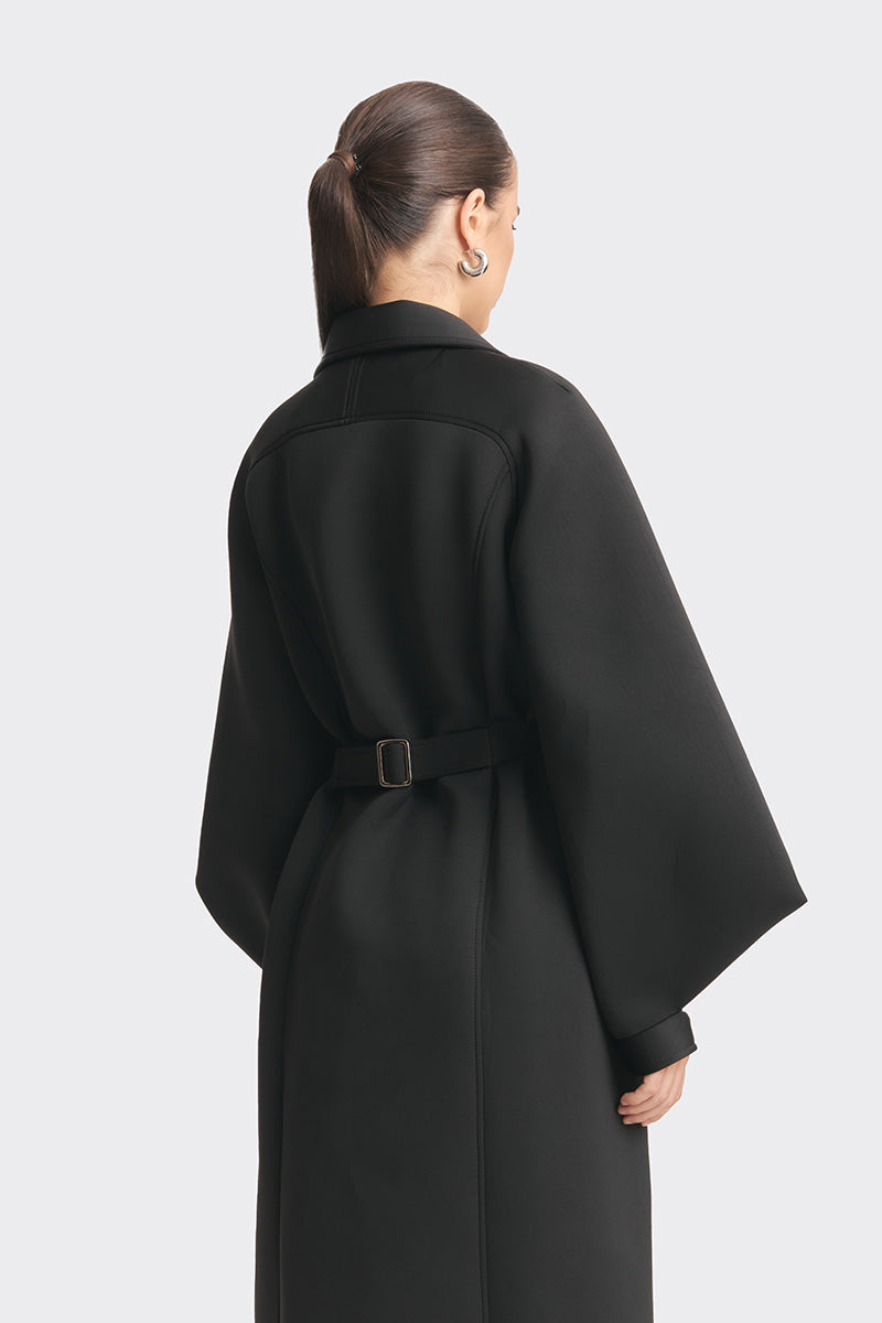 Black MS. Doll coat by Stolen Stores displayed on a mannequin, featuring a stylish design with a tailored fit.