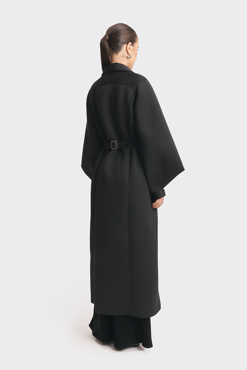 Black coat from the MS. DOLL collection by Stolen Stores, featuring stylish design and tailored fit, shown on a mannequin.