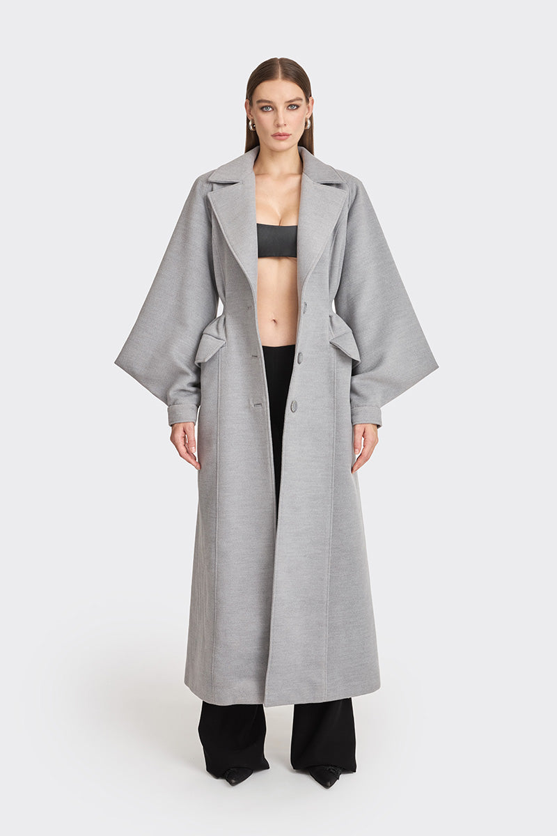 Stolen Stores Ms. Doll gray coat displayed on a hanger, featuring a stylish, tailored design with a classic collar and button closure.