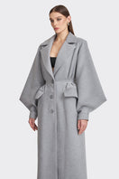 Gray coat from the MS. DOLL collection by Stolen Stores, displayed on a mannequin, featuring a stylish and modern design.