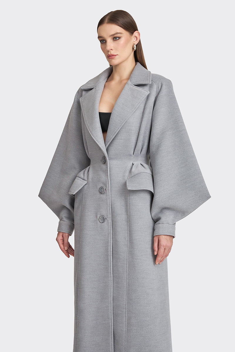 Gray coat from the MS. DOLL collection by Stolen Stores, displayed on a mannequin, featuring a stylish and modern design.