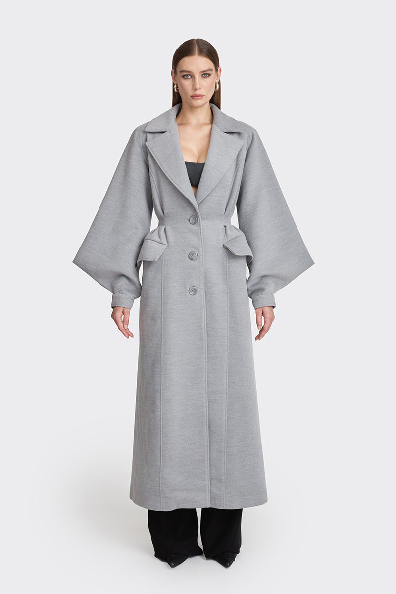 Gray coat from Stolen Stores' Ms. Doll collection, displayed on a mannequin, showcasing stylish, fall-ready outerwear.