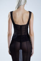 Red and black bustier top from Stolen Stores featuring a fitted design with lace accents and adjustable straps.