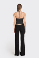 Black side bustier top from Stolen Stores, featuring a fitted design and structured style, shown on a model.