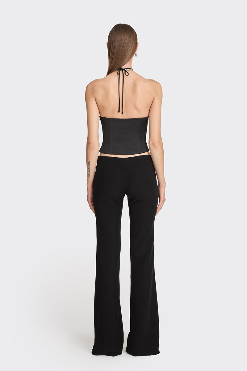 Black side bustier top from Stolen Stores, featuring a fitted design and structured style, shown on a model.