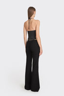 Black side bustier top from Stolen Stores featuring a fitted design and stylish detailing, shown on a model.