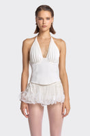 White MS. Pleat corset top by Stolen Stores, featuring pleated design and structured fit, displayed on a neutral background.