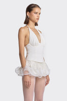 White pleated corset top by Stolen Stores, featuring structured design and on-trend style, displayed on a mannequin.